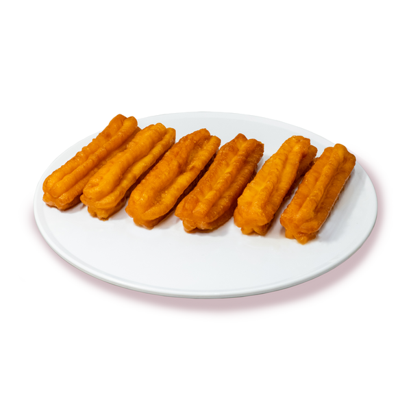 Чиния с прясно приготвени 'Толумбички' от сладкарница Маргарита, златисти и напоени със сироп.